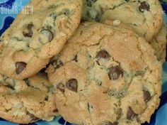 chocolate chip cookies piled on top of each other in a blue plate with polka dots