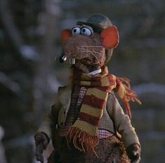 a stuffed animal wearing a hat and scarf