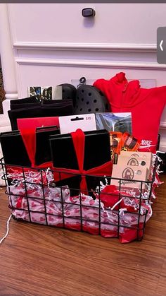 a basket filled with lots of items sitting on top of a wooden floor