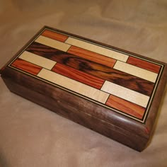 a wooden box sitting on top of a bed