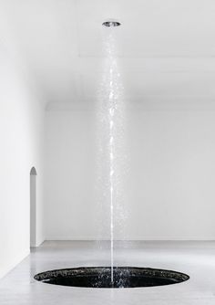 a black and white photo of a sprinkler in the middle of a room