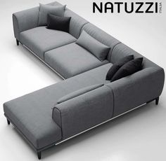 a couch that is sitting on top of a white surface with pillows and the words nattuzzi above it