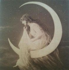 a woman sitting on the moon with her hands to her face and hair blowing in the wind