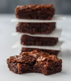 four pieces of brownie stacked on top of each other in front of one another