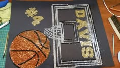 a basketball themed birthday cake on a table with scissors and other items to make it