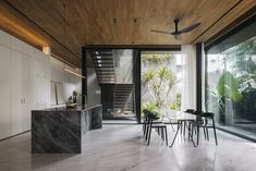 an open living room and dining area with stairs leading up to the second floor that has glass doors on both sides