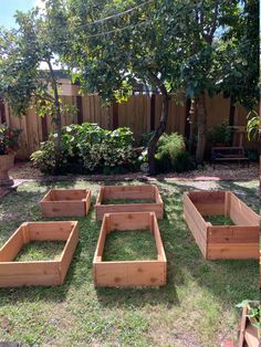 several wooden raised garden beds in the yard