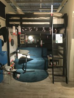 a bedroom with bunk beds and blue carpeted flooring in front of a loft bed