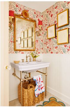 a white sink sitting under a mirror next to a wall mounted faucet in a bathroom