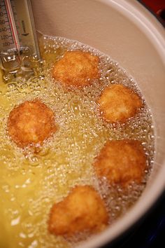 some food is being cooked in a pot with water and oil on the stove top