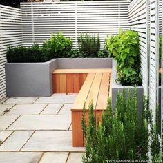 a wooden bench sitting in the middle of a garden