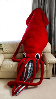 an octopus stuffed animal laying on top of a couch