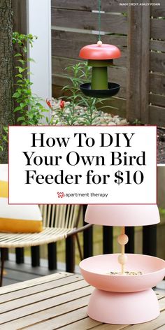 a pink bird feeder sitting on top of a wooden table next to a planter