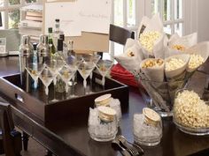 a dining room table filled with lots of food and wine glasses on top of it