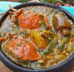 a bowl filled with soup on top of a wooden table