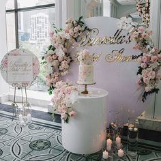 a wedding cake with flowers and candles in front of a sign that says married by the bride