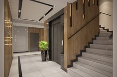 an entry way with stairs, potted plant and chandelier