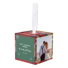 a christmas ornament hanging from the side of a box with a photo on it