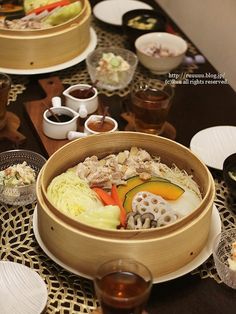 a table topped with plates and bowls filled with food