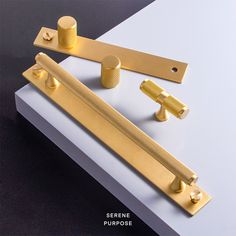 an assortment of brass handles and knobs on top of a white surface with black background