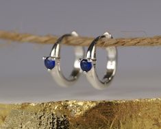 Blue Sapphire Hoop Earrings. Sterling Silver Huggie Earrings. September Sapphire Earrings. It has long ben believed that wearing a persons correct birthstone has therapeutic or talismanic properties. Stunning pale blue (sapphire) cubic zirconia's are set in these high quality huggie hoop earrings that are designed to celebrate each months birthstone. Whether worn as a birthstone or just because you love the colour these earrings are truly beautiful, they are secure in the ear and look stunning d Sapphire Hoop Earrings, Silver Huggie Earrings, Small Silver Hoop Earrings, September Sapphire, Huggie Earrings Silver, Hoop Earrings Silver, Round Sapphire, Jewelry Accessories Ideas, Jewelry Lookbook