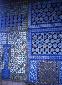 some blue and white tiles on the side of a building