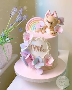 there is a small cake with flowers on the top and a cat figurine