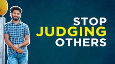 a man standing next to a pole with the words stop judging others