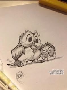 a drawing of an owl and kitten sitting next to each other on top of a piece of paper