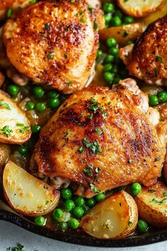 chicken and potatoes in a skillet with peas