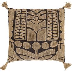 a brown and black pillow with tassels on the front, featuring an intricate design