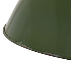 a green lamp shade with rusted metal trim