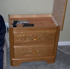 a small wooden chest sitting next to a wall with a phone on top of it