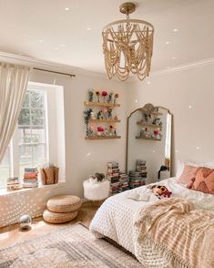 a bedroom with a large bed and a chandelier hanging from the ceiling