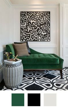 a green couch sitting in front of a black and white rug on top of a floor