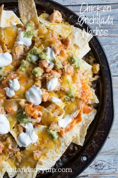 chicken enchilada nachos in a cast iron skillet