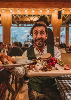 a man holding a tray with food on it