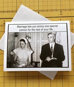 a card with an image of a man and woman sitting next to each other on top of a piece of paper