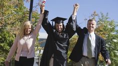 two men and a woman in graduation gowns holding their hands up to the sky