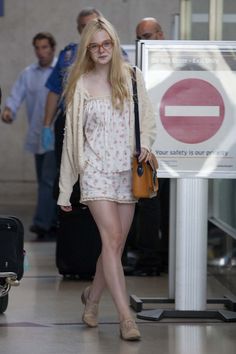 a woman walking down the street in short shorts