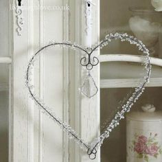 a heart shaped decoration hanging from the side of a door