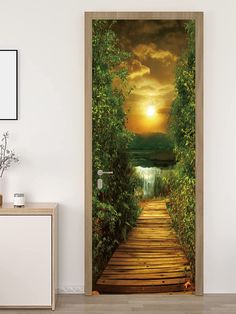 an open door with a wooden walkway leading to a lake and sunset in the background