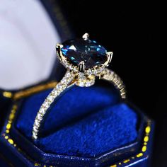 an engagement ring in a blue velvet box