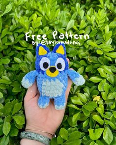 a hand holding a small stuffed animal in front of some bushes with the text free pattern