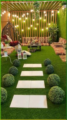 an outdoor living area with grass and lights