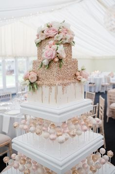 three tiered wedding cake with pink flowers on top