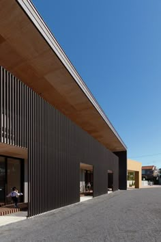 the outside of a building with people sitting at tables