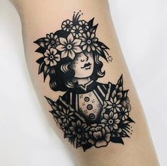 a girl with flowers on her head is shown in black and white tattoo art work