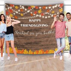 a group of people standing in front of a happy thanksgiving sign