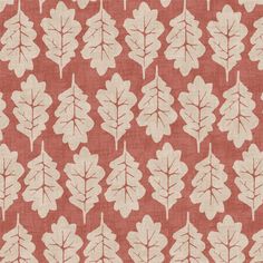 an orange and white fabric with leaves on the front, in shades of red and beige